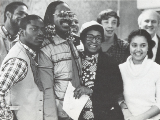 "Stevie Wonder poses with staff and students after impromptu performance at Montgomery Blair High School, Jan. 14, 1981." Via. Blair 1981 yearbook.